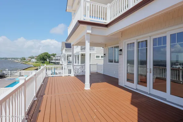 a balcony with wooden floor and city view