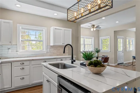 a view of kitchen with sink microwave and refrigerator