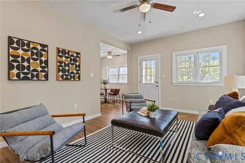a view of a room with furniture and wooden floor