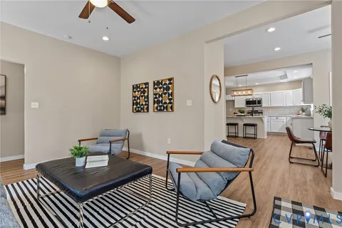 a room with chandelier fan and windows