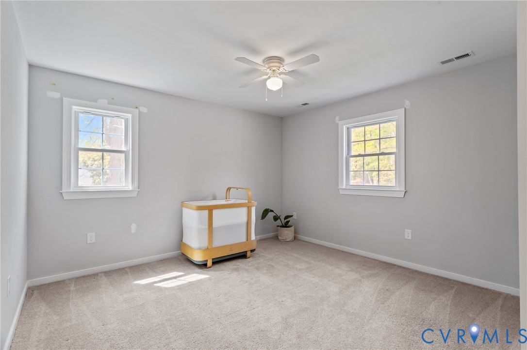 2701 Perdue Avenue Chester, VA 23831 - Photo 20 of 54 a room with chandelier fan and windows