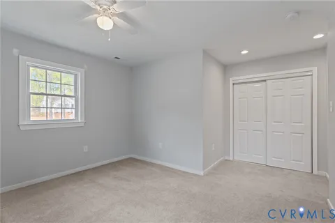 a en suite bathroom with a granite countertop sink and a mirror