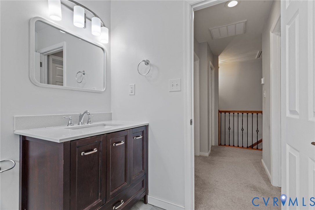 2701 Perdue Avenue Chester, VA 23831 - Photo 23 of 54 a en suite bathroom with a granite countertop sink and a mirror