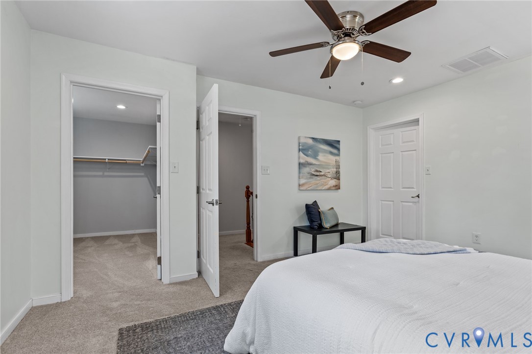 2701 Perdue Avenue Chester, VA 23831 - Photo 26 of 54 a bedroom with a bed and a chandelier