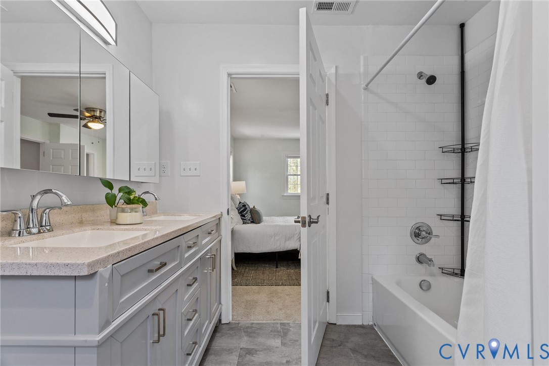 2701 Perdue Avenue Chester, VA 23831 - Photo 31 of 54 a spacious bathroom with a tub sink double vanity and hallway