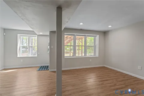 a balcony with wooden floor and outdoor seating