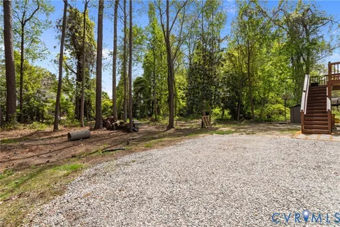 a view of a house with a yard patio and fire pit