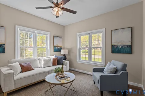 a living room with furniture and a potted plant