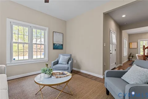 a view of a livingroom with furniture wooden floor and windows