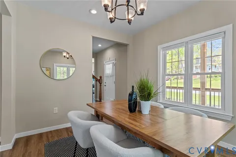 a kitchen with stainless steel appliances granite countertop a sink a stove a microwave a refrigerator cabinets and a window