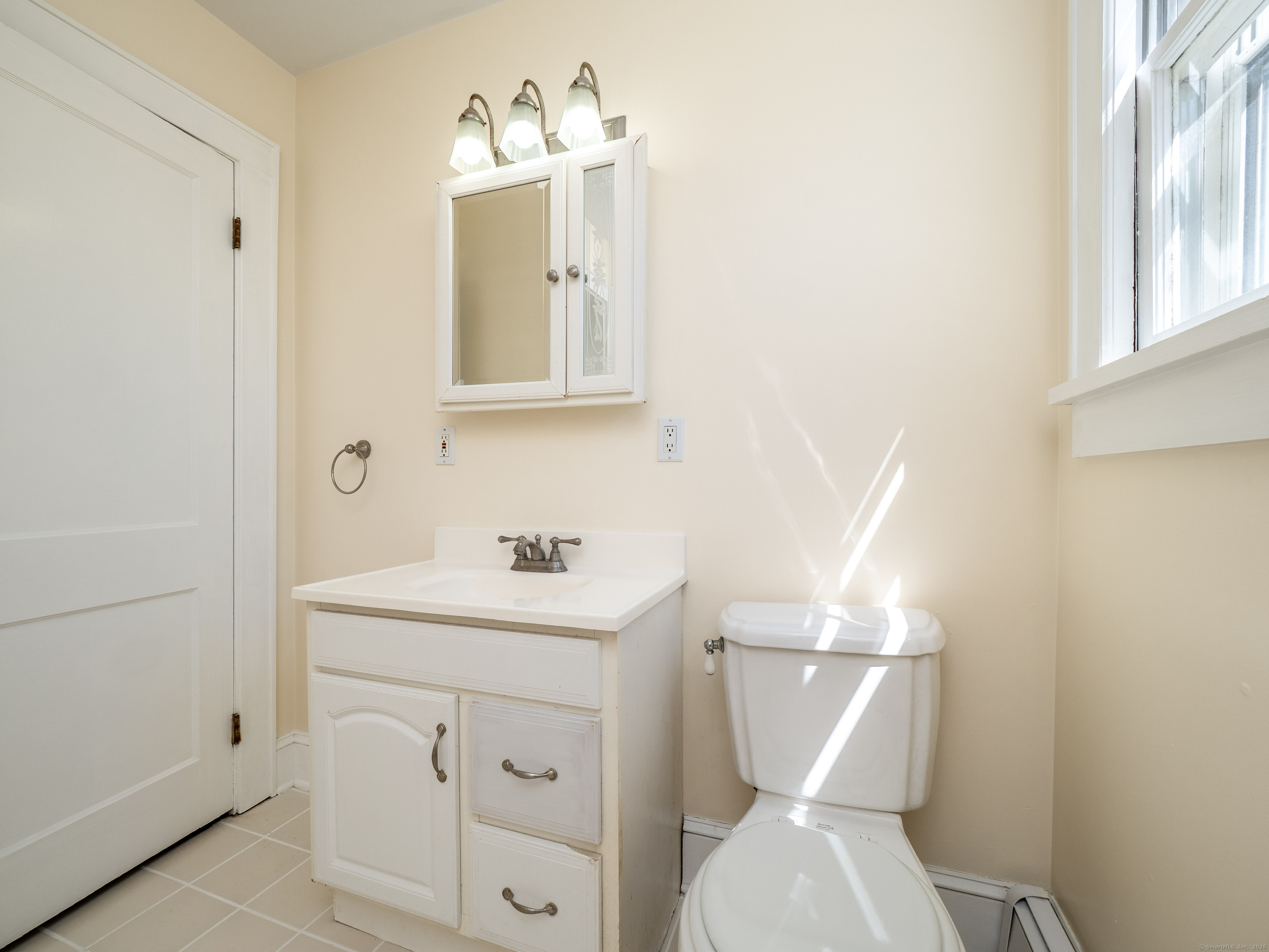 159 Barry Avenue Ridgefield, CT 06877 - Photo 13 of 39 a bathroom with a toilet sink and mirror