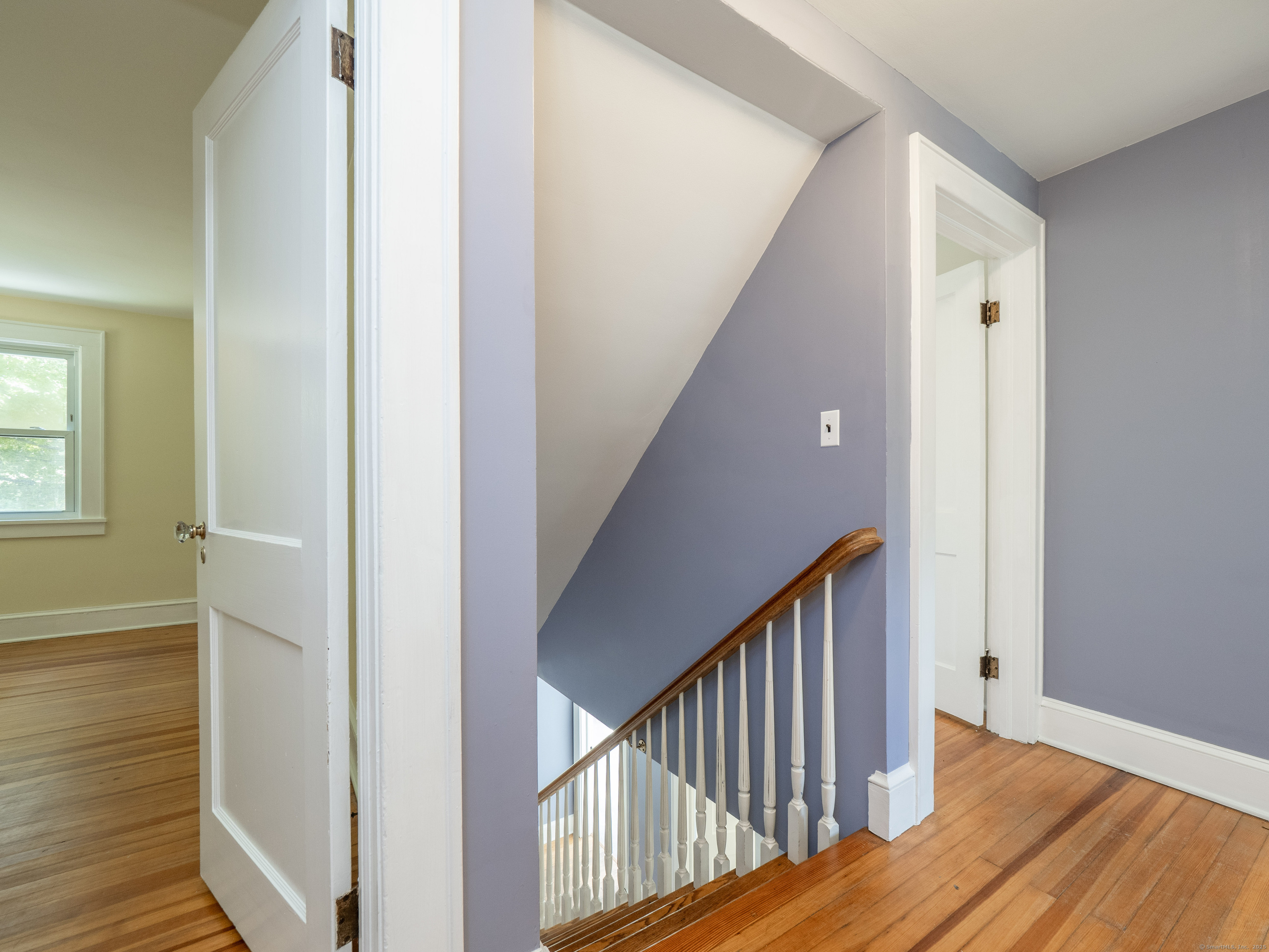 159 Barry Avenue Ridgefield, CT 06877 - Photo 14 of 39 a view of a hallway with wooden floor and staircase