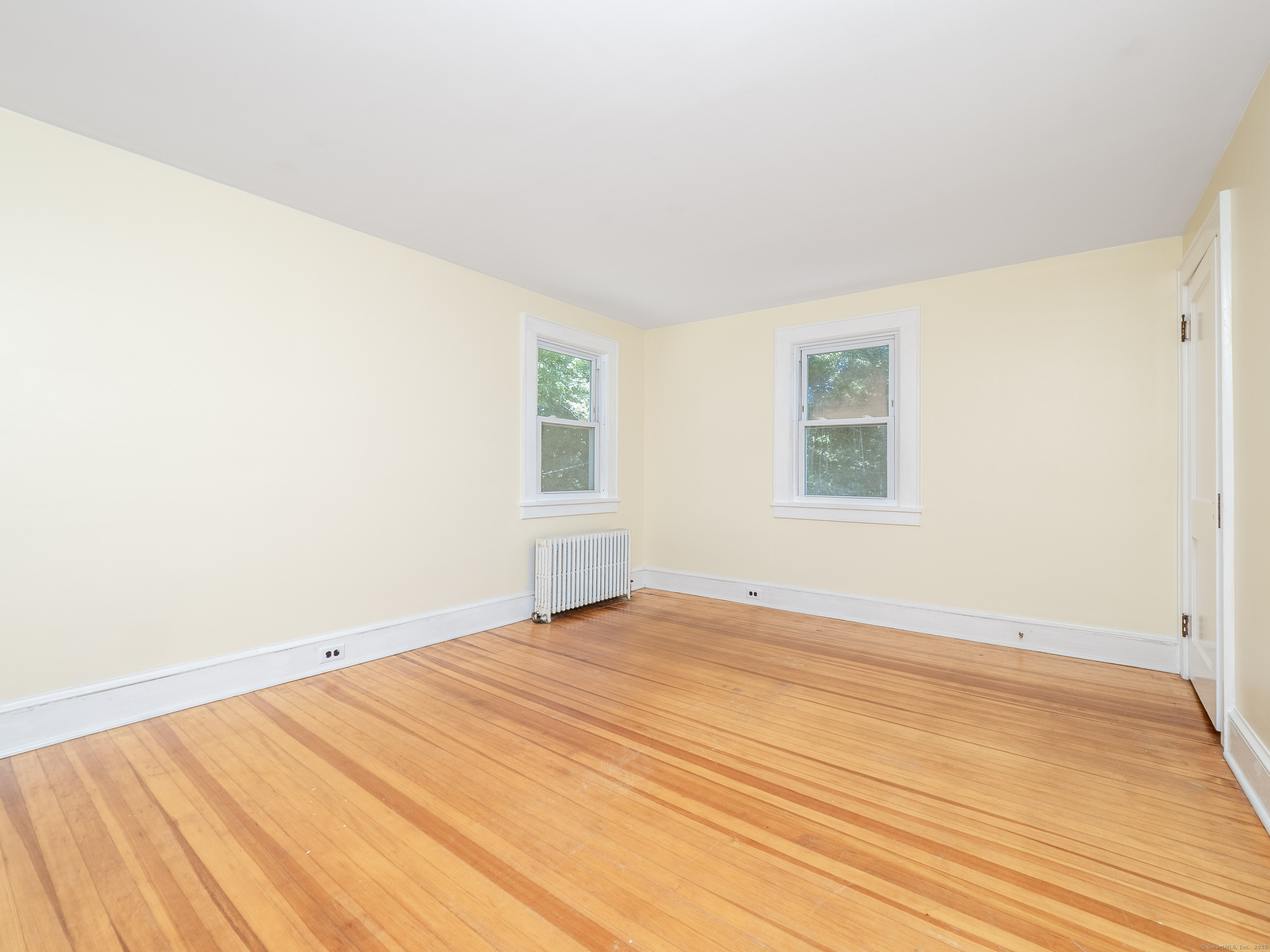 159 Barry Avenue Ridgefield, CT 06877 - Photo 15 of 39 a view of an empty room with wooden floor and a window