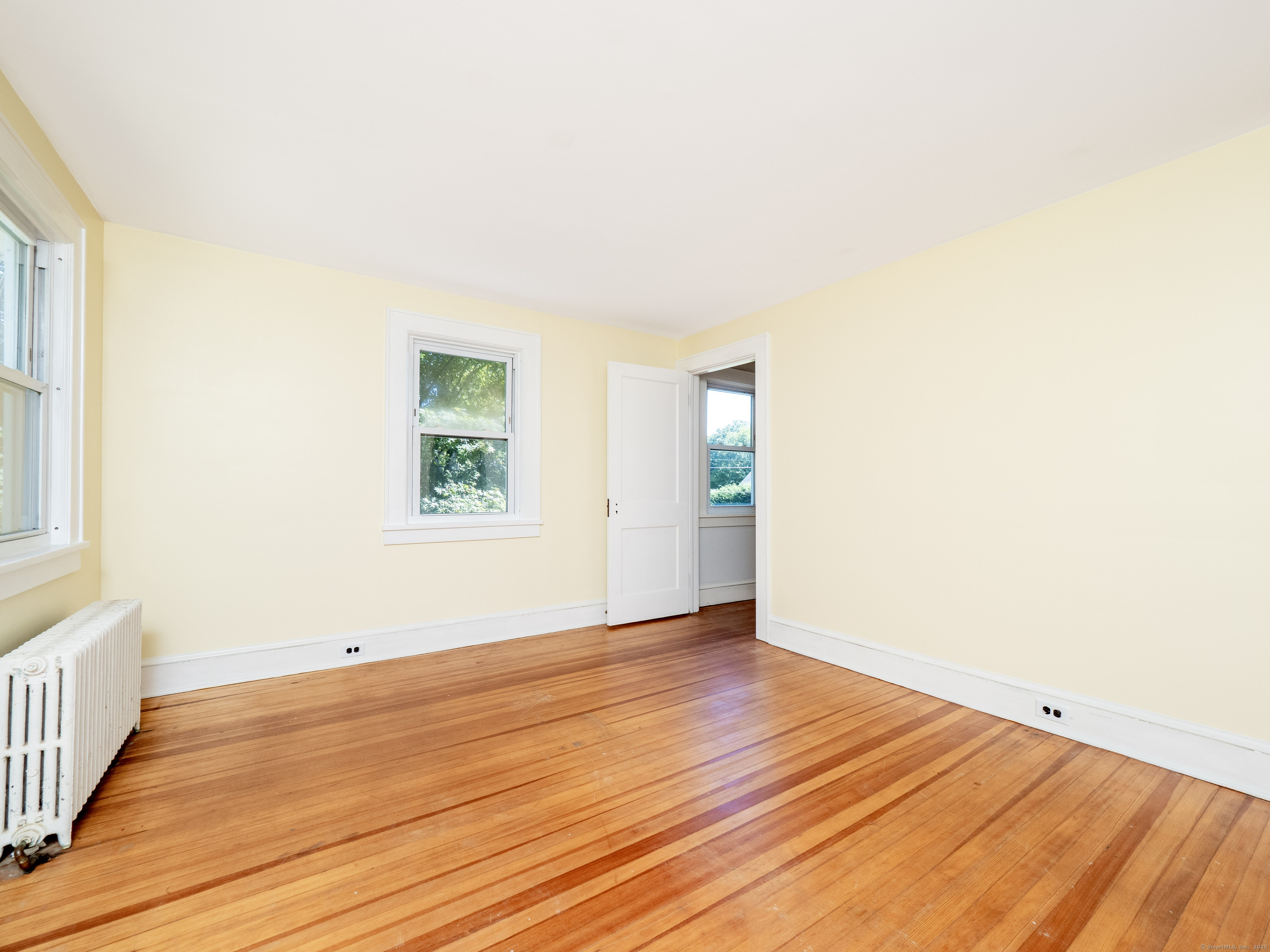 159 Barry Avenue Ridgefield, CT 06877 - Photo 16 of 39 an empty room with wooden floor and windows
