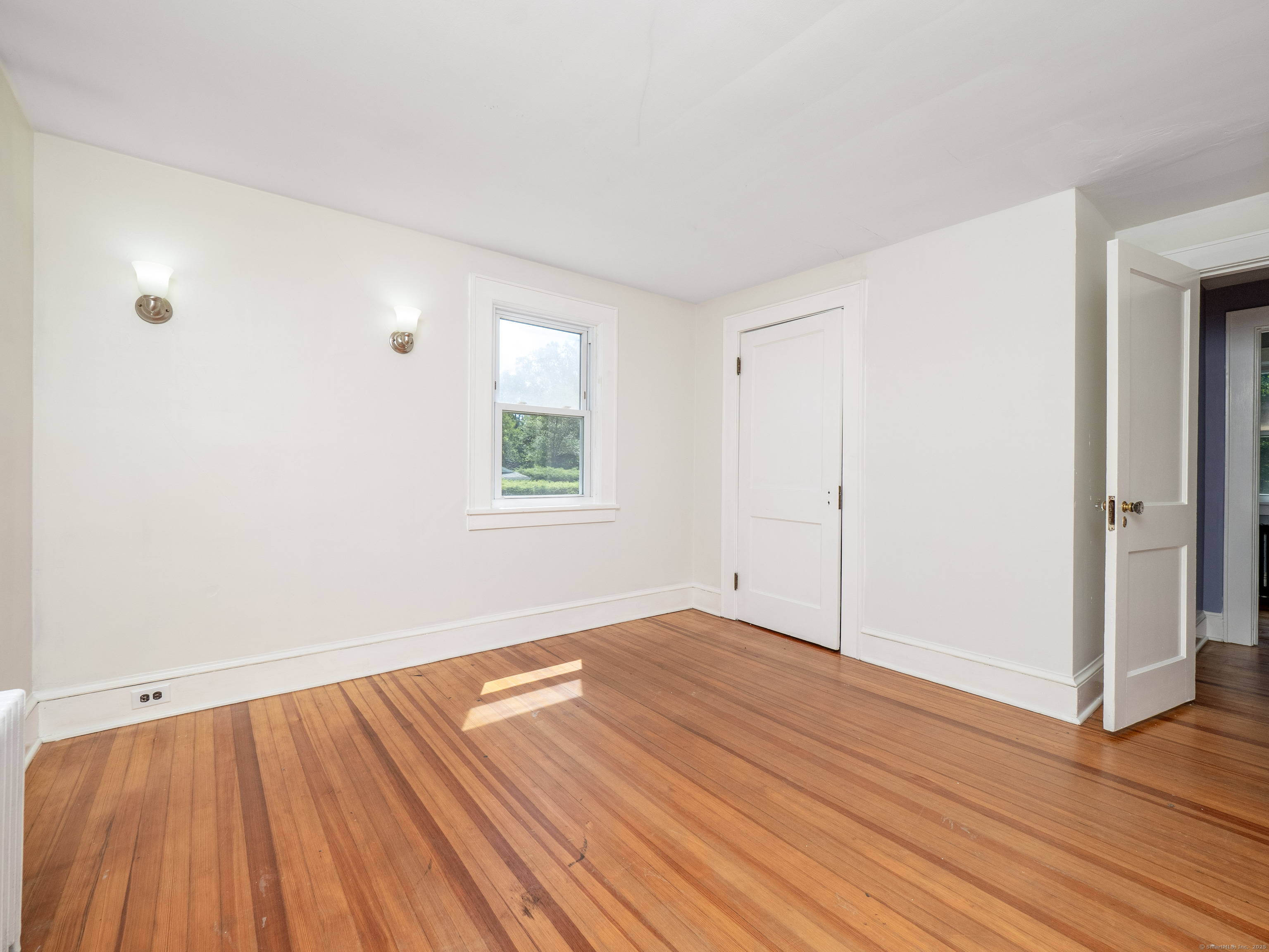 159 Barry Avenue Ridgefield, CT 06877 - Photo 19 of 39 an empty room with wooden floor and windows