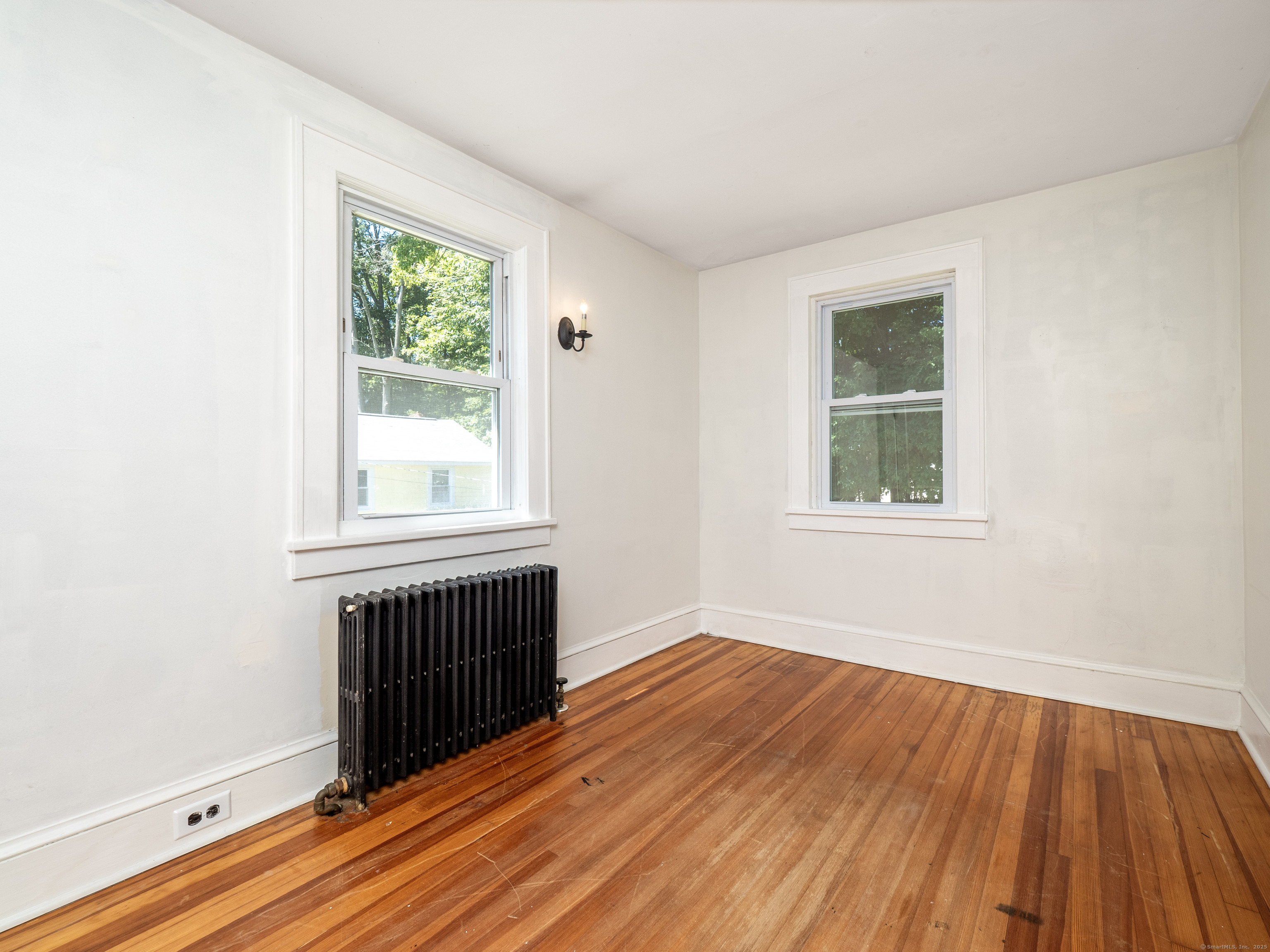 159 Barry Avenue Ridgefield, CT 06877 - Photo 20 of 39 an empty room with wooden floor and windows