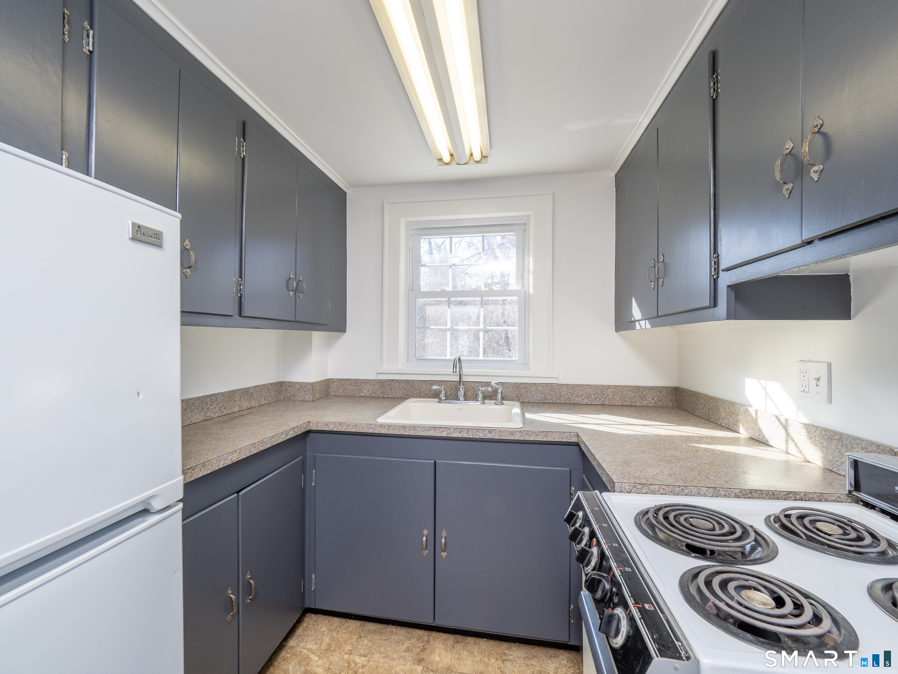 159 Barry Avenue Ridgefield, CT 06877 - Photo 36 of 39 a kitchen with a sink a stove and cabinets