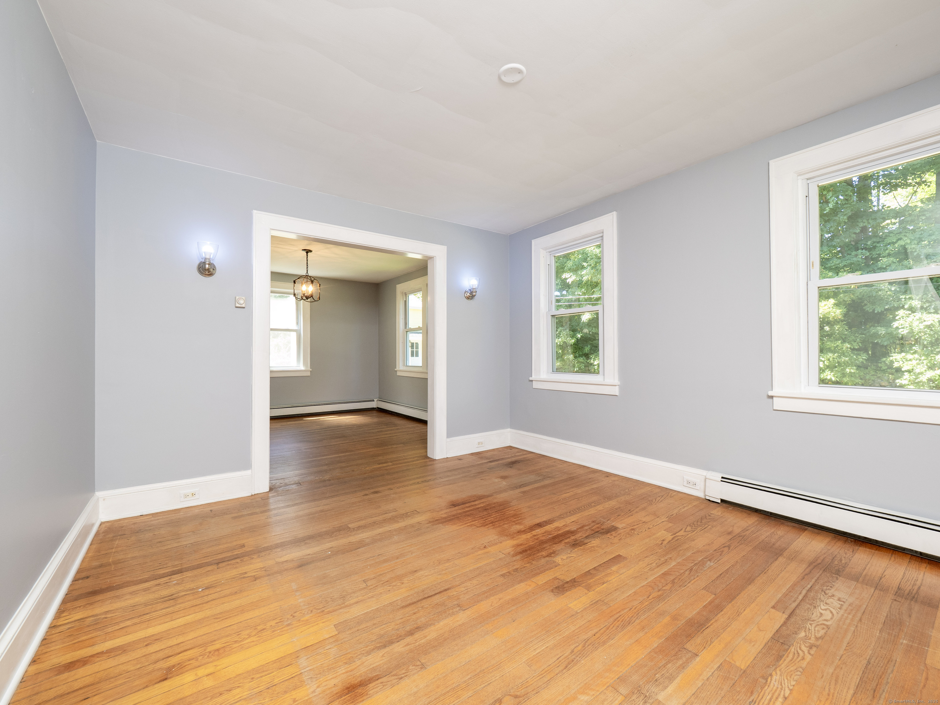 159 Barry Avenue Ridgefield, CT 06877 - Photo 10 of 39 a view of an empty room with wooden floor and a window