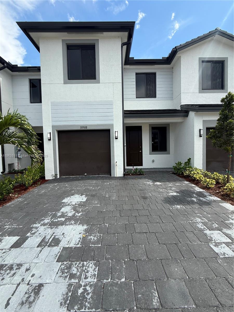 a view of a house with a yard and garage