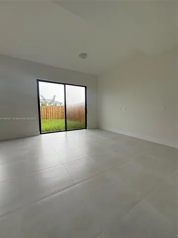 a view of an empty room with a balcony