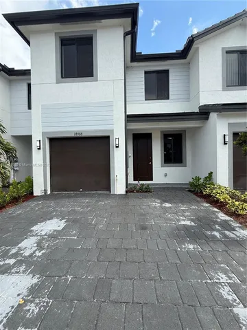 a view of a house with a yard and garage