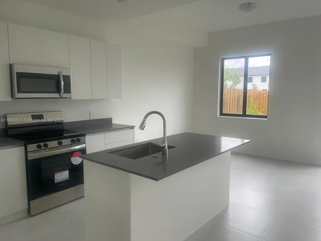 a kitchen with a stove and a sink