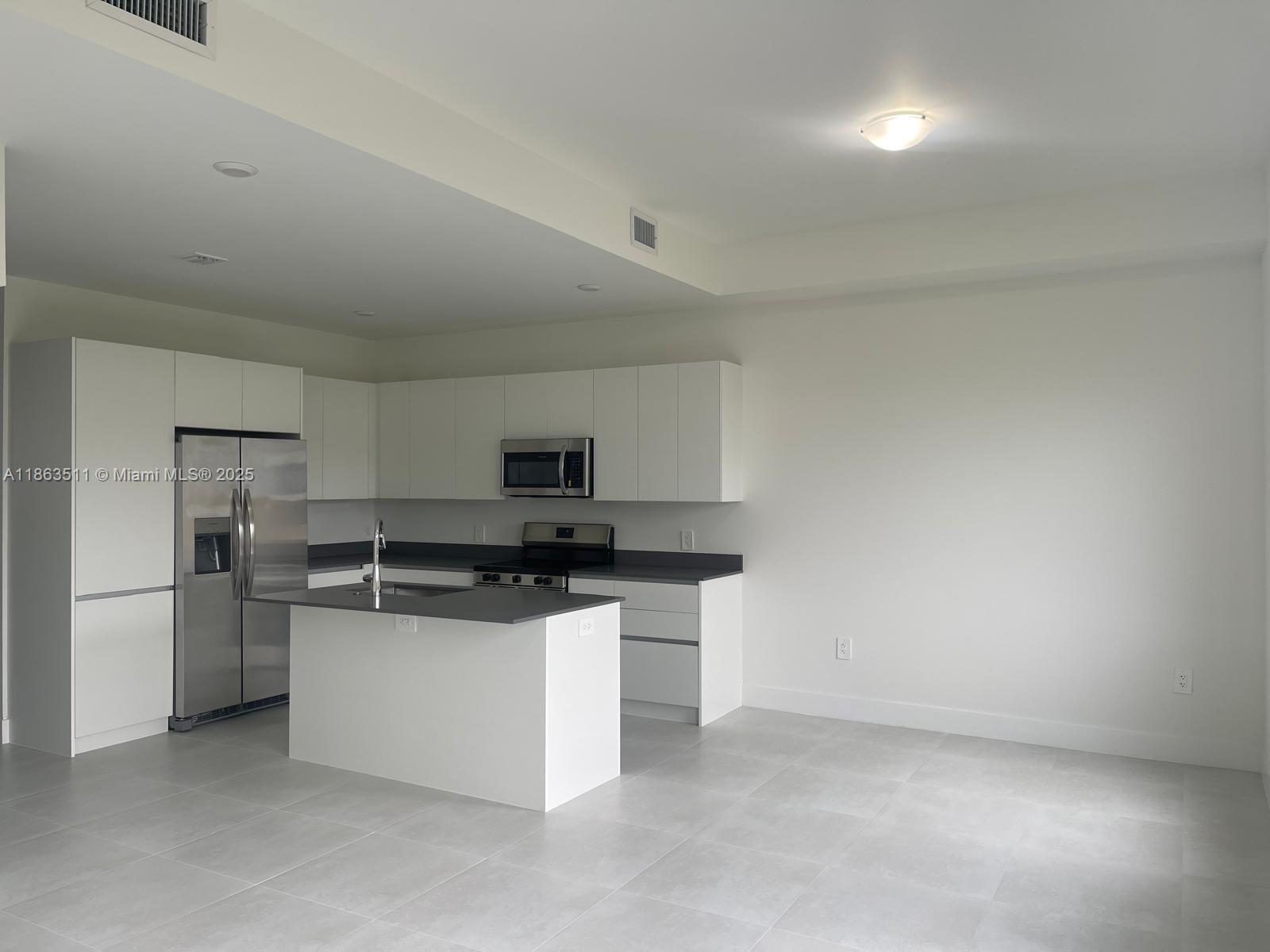 18988 Southwest 344th Terrace Homestead, FL 33034 - Photo 8 of 28 a kitchen with stainless steel appliances a sink and a refrigerator