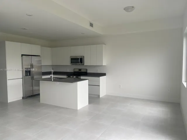 a kitchen with cabinets and appliances