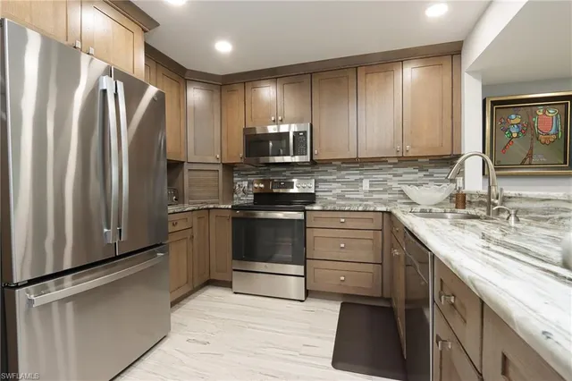 a kitchen with a refrigerator sink and microwave