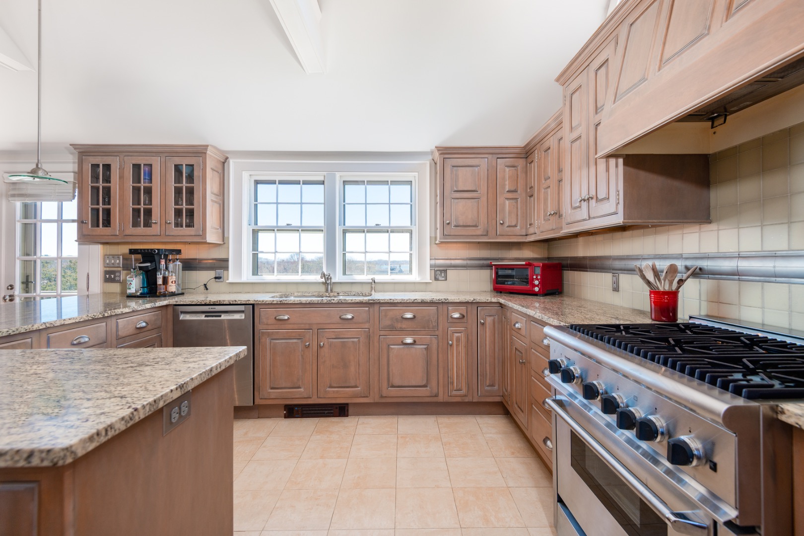 5 Old Quidnet Milk Route Nantucket, MA 02554 - Photo 14 of 62 a kitchen with stainless steel appliances granite countertop a stove and a sink