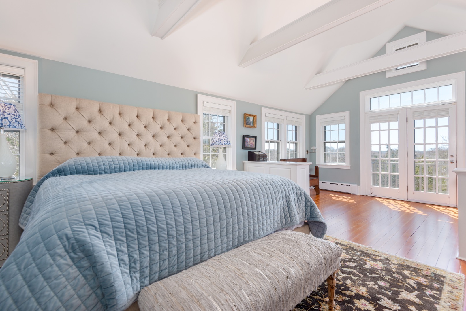 5 Old Quidnet Milk Route Nantucket, MA 02554 - Photo 23 of 62 a bedroom with a large bed and a wooden floor