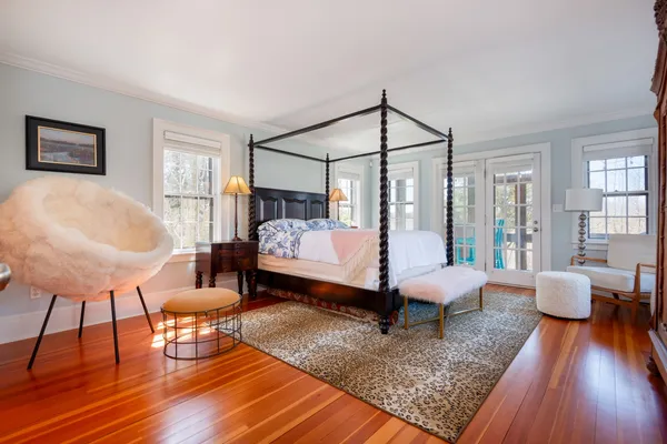 a bedroom with a bed a table and chair