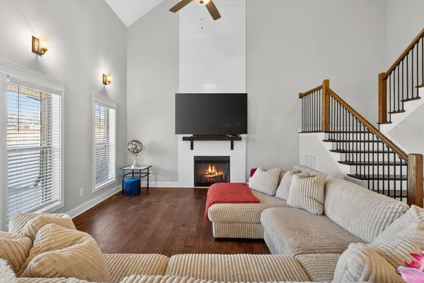 a living room with furniture and a fireplace
