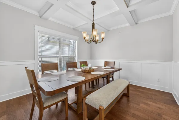 a view of a dining room with a table and chairs