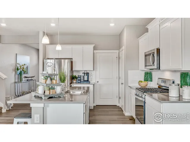 a kitchen with white cabinets and appliances