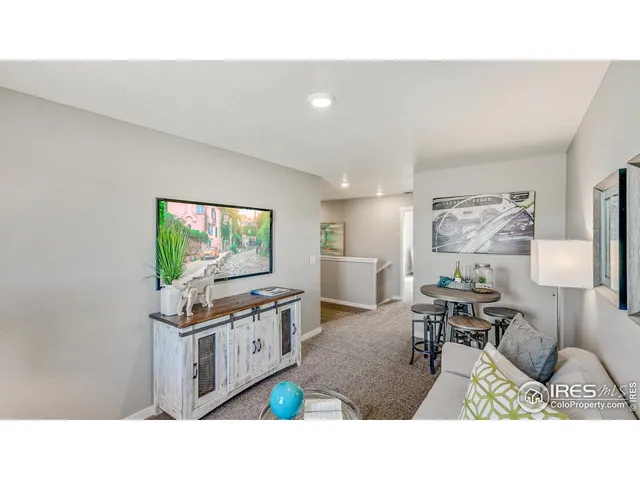 a living room with furniture a flat screen tv and a table