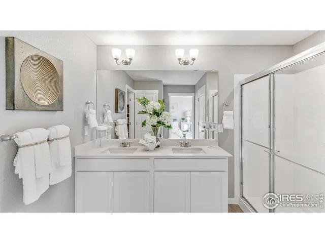 a bathroom with a sink vanity granite and a mirror