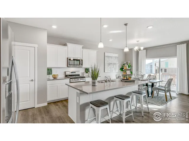 a kitchen with counter space appliances and a dining table