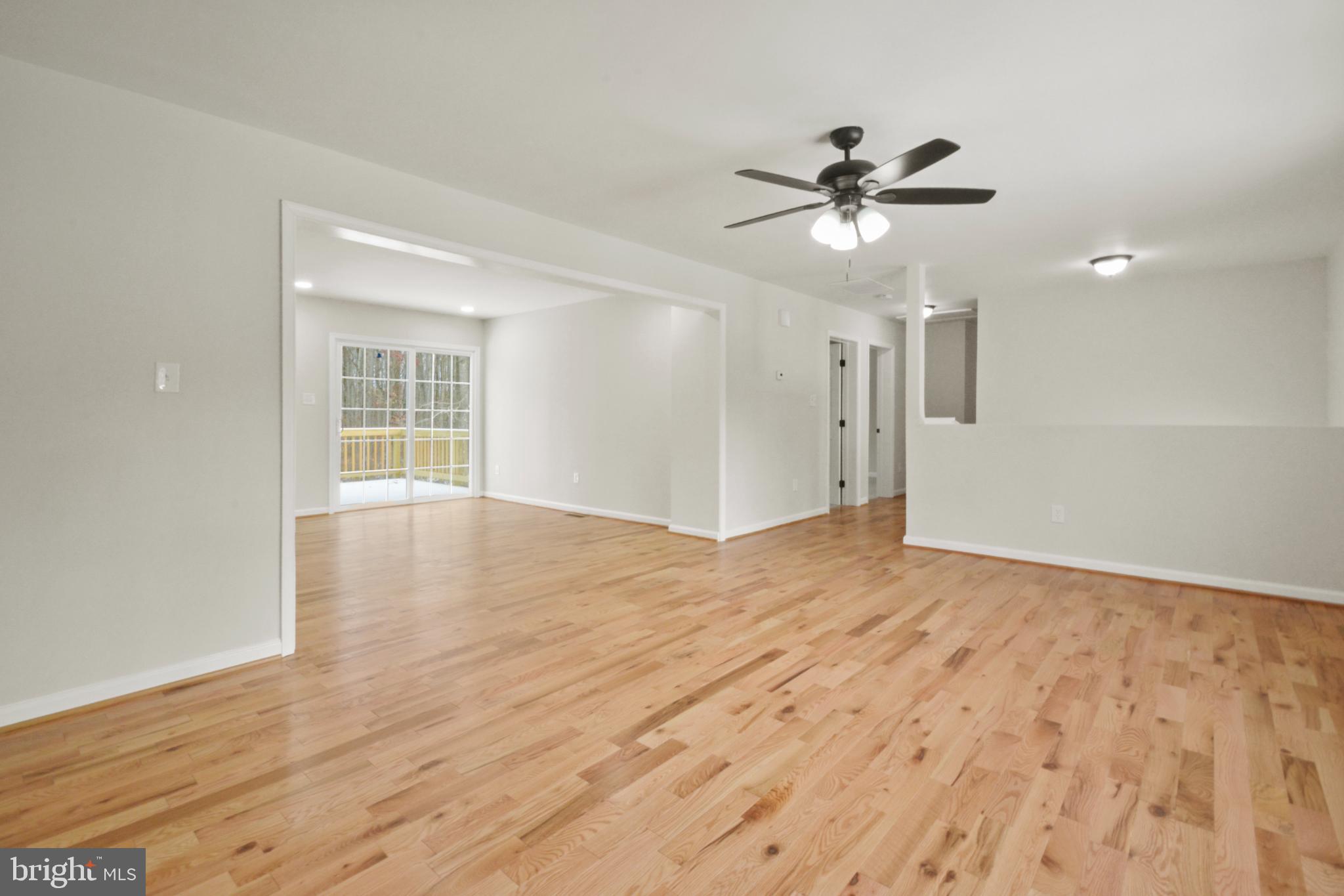 18487 Clay Hill Road Stevensburg, VA 22741 - Photo 12 of 41 a view of empty room with wooden floor and fan