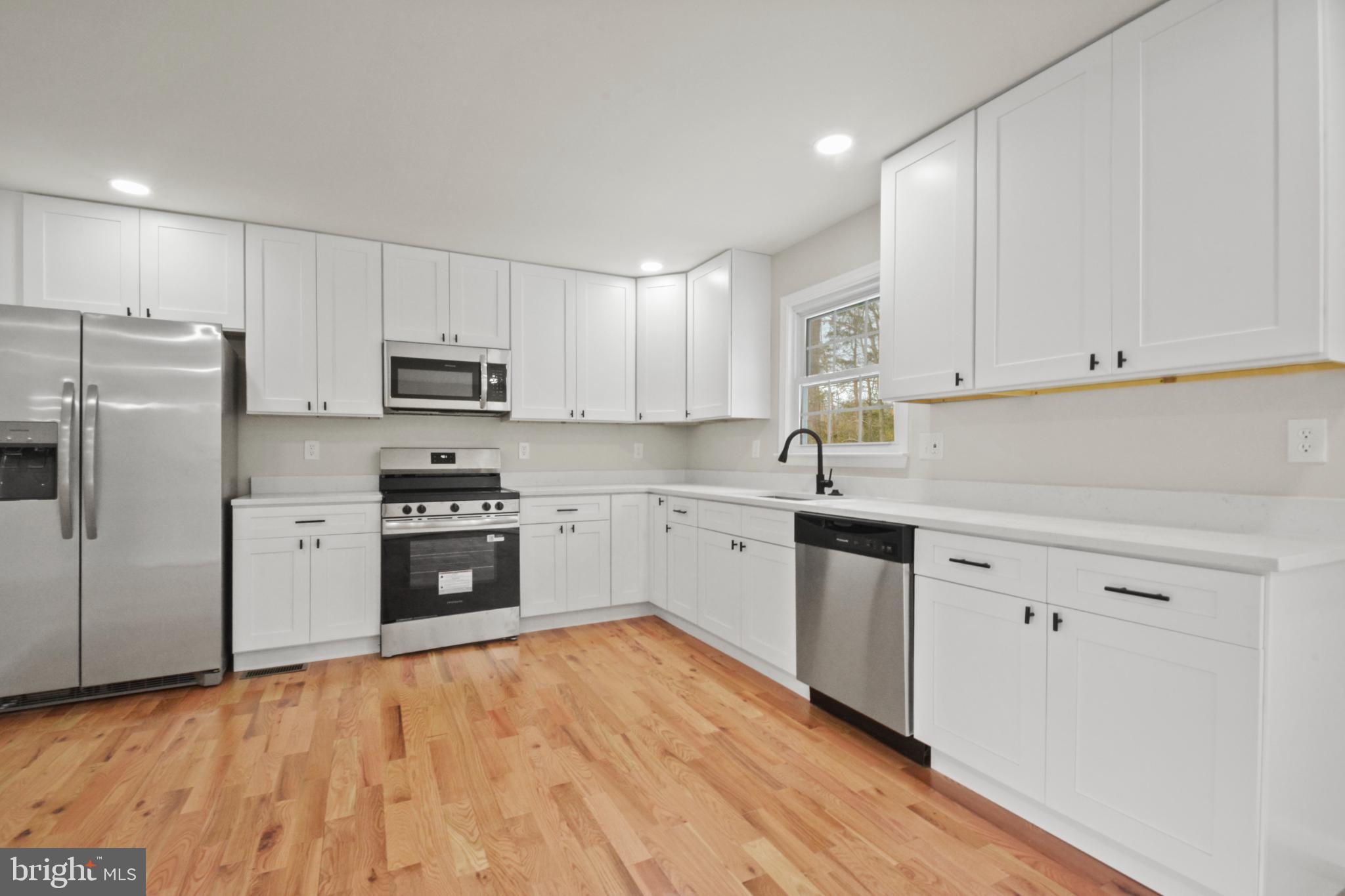 18487 Clay Hill Road Stevensburg, VA 22741 - Photo 19 of 41 a kitchen with granite countertop white cabinets and stainless steel appliances