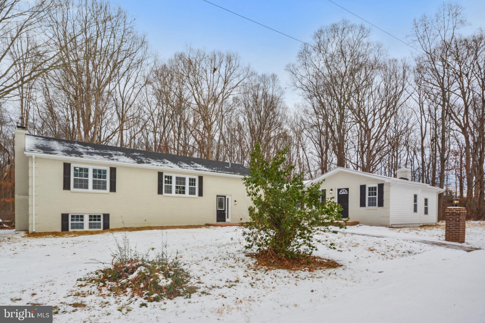 18487 Clay Hill Road Stevensburg, VA 22741 - Photo 2 of 41 a front view of a house with a dirt yard and a large tree