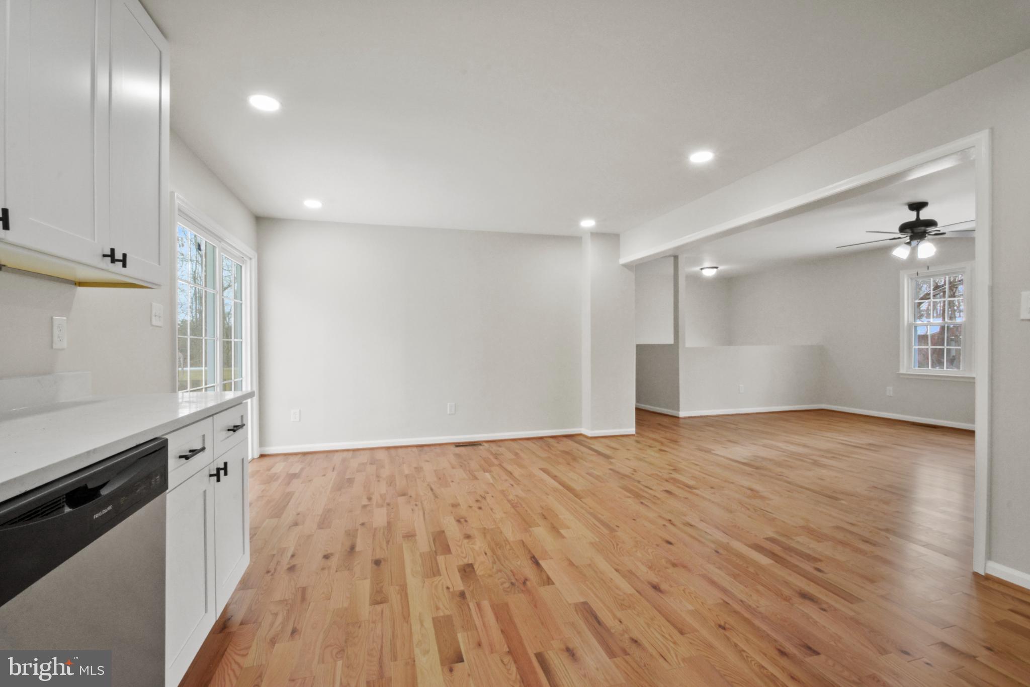 18487 Clay Hill Road Stevensburg, VA 22741 - Photo 21 of 41 a view of an empty room with wooden floor and kitchen