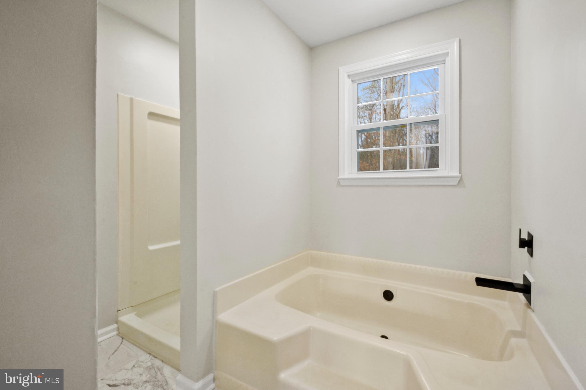 18487 Clay Hill Road Stevensburg, VA 22741 - Photo 25 of 41 a bathroom with a tub