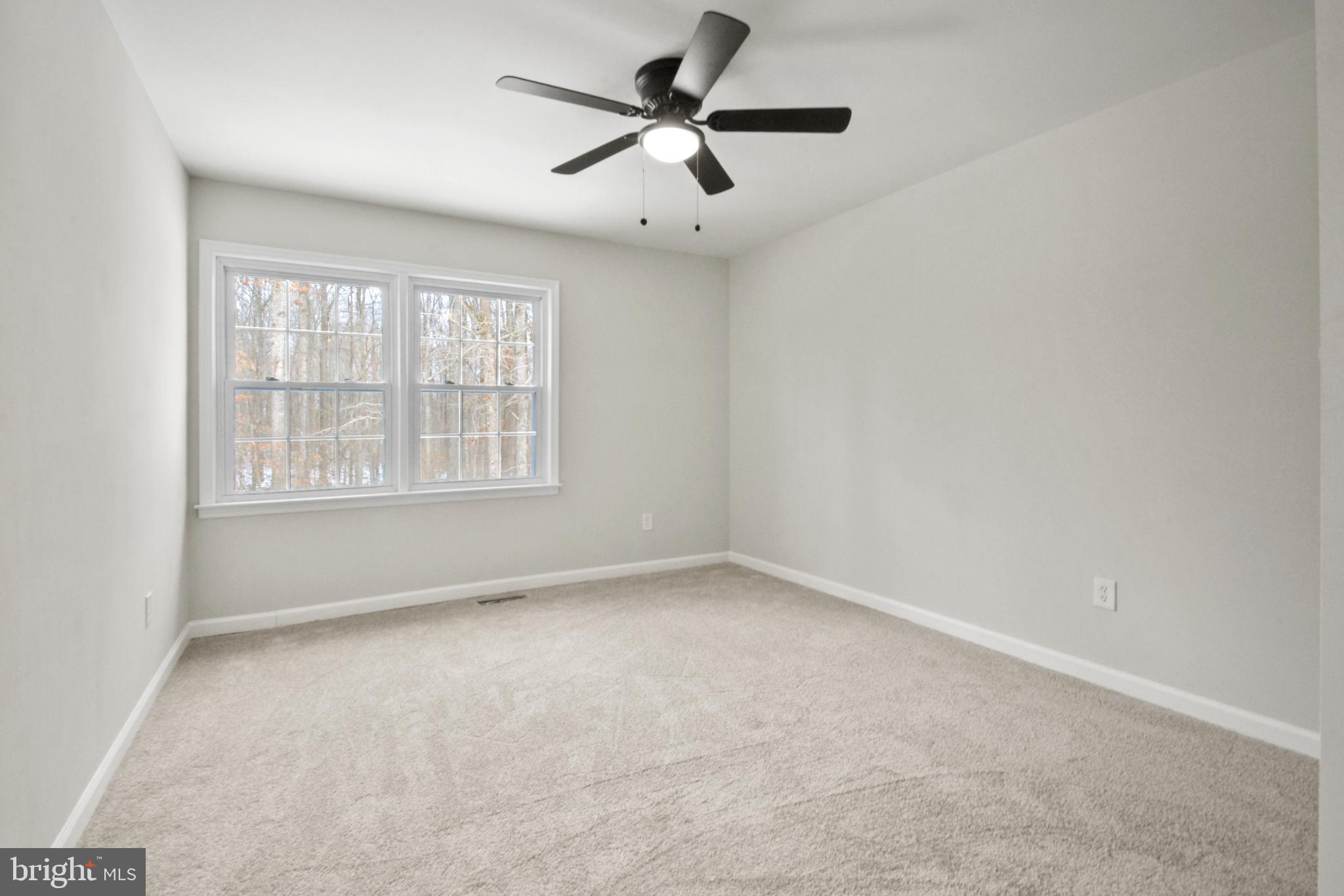 18487 Clay Hill Road Stevensburg, VA 22741 - Photo 27 of 41 an empty room with ceiling fan and windows