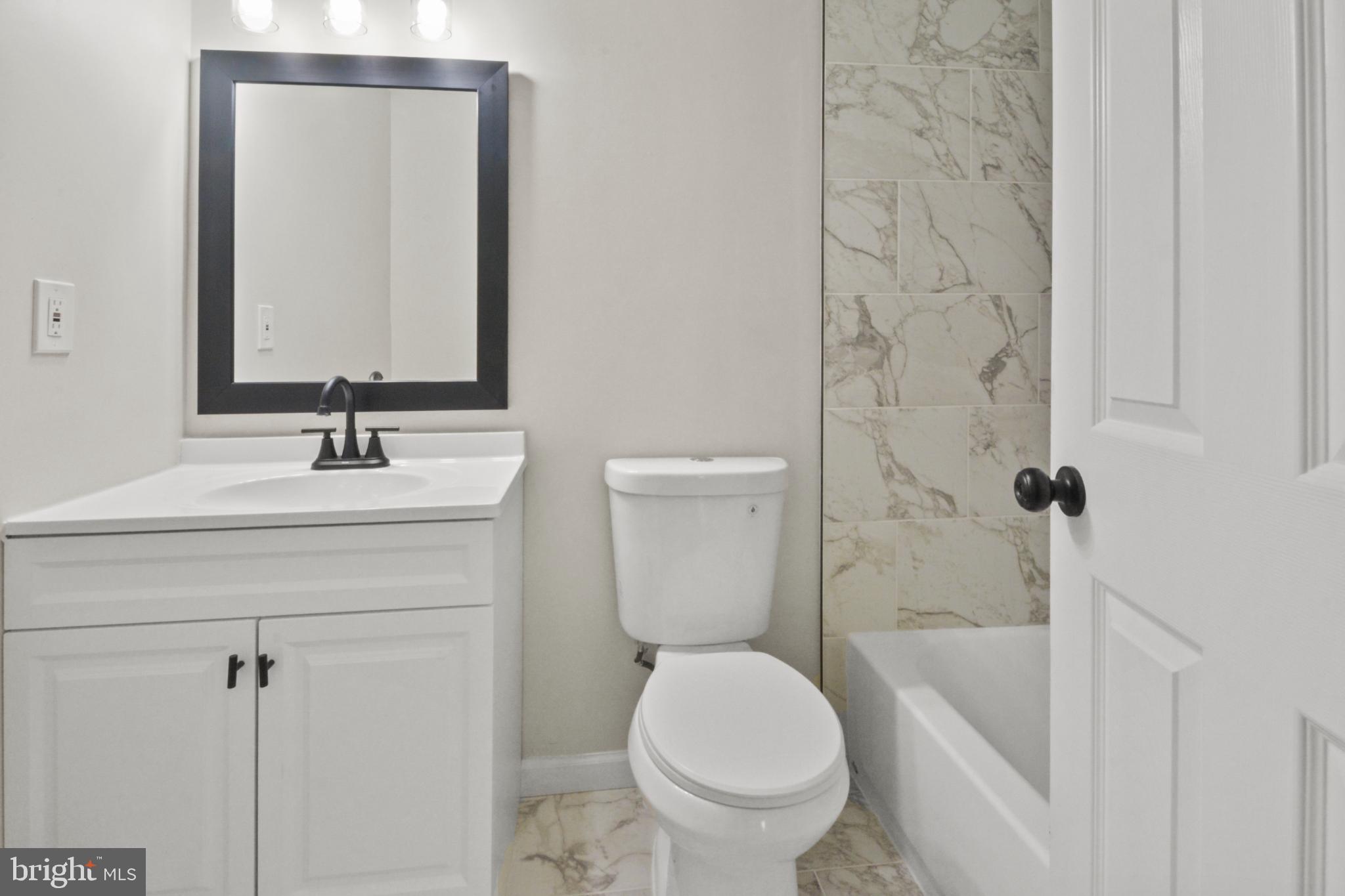 18487 Clay Hill Road Stevensburg, VA 22741 - Photo 29 of 41 a bathroom with a sink a toilet and shower