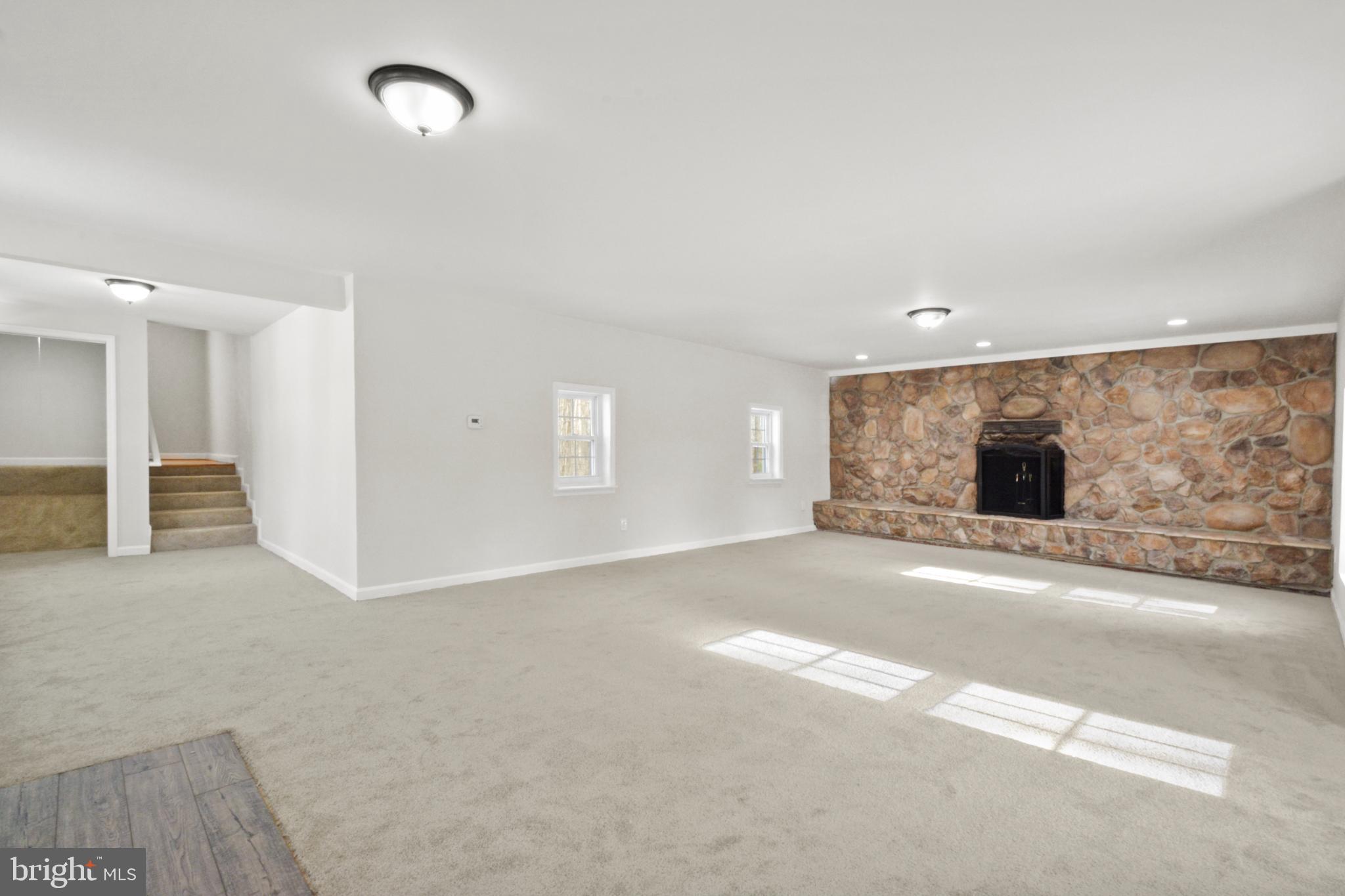 18487 Clay Hill Road Stevensburg, VA 22741 - Photo 31 of 41 an empty room with windows and fireplace