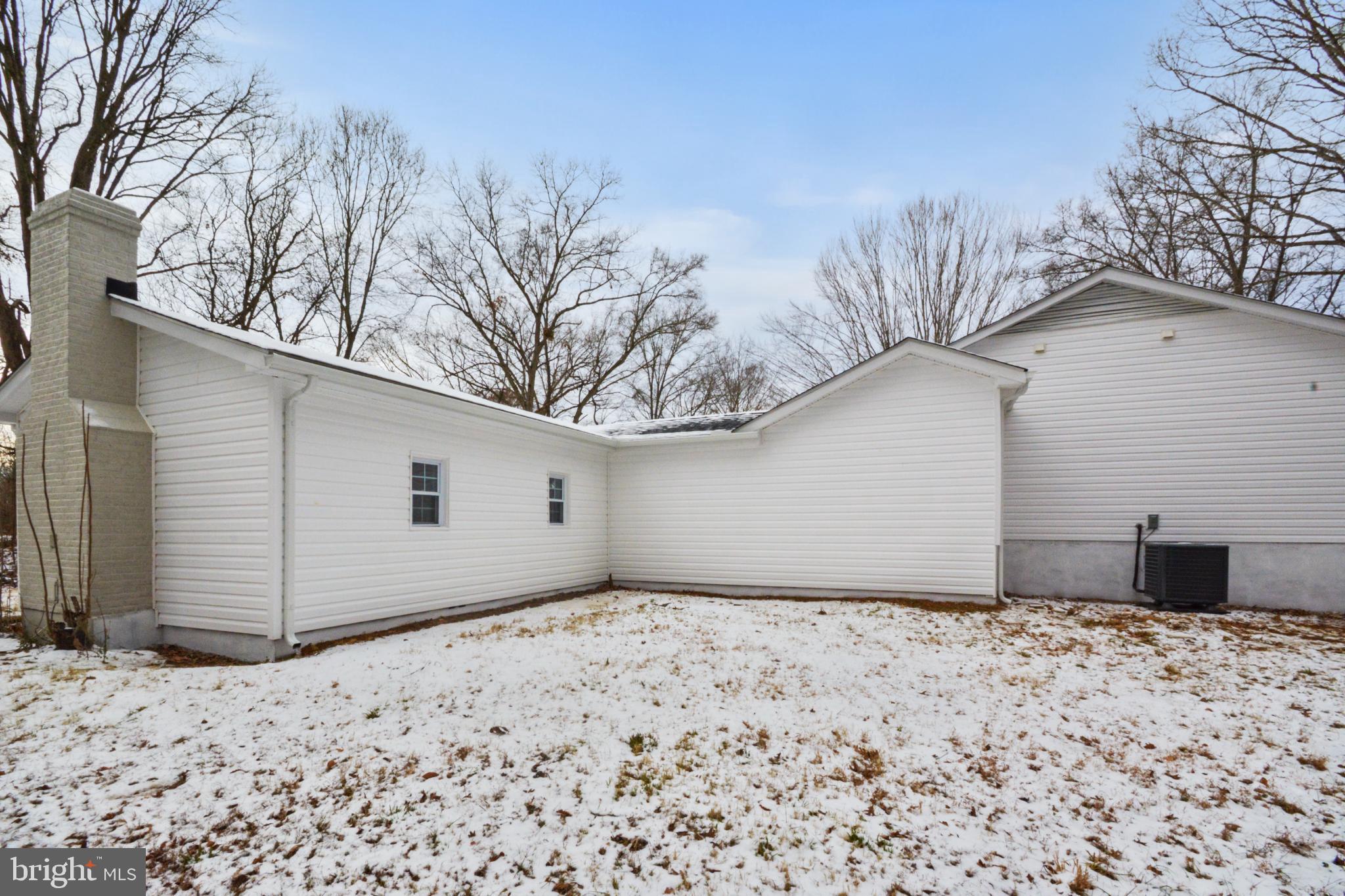 18487 Clay Hill Road Stevensburg, VA 22741 - Photo 5 of 41 a view of a backyard with a large tree