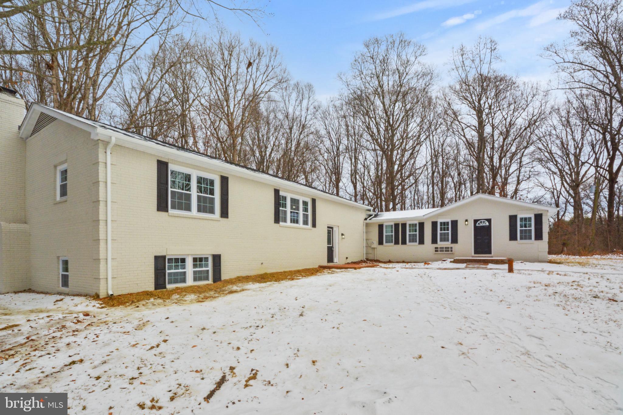 18487 Clay Hill Road Stevensburg, VA 22741 - Photo 9 of 41 a front view of a house with a yard covered in snow