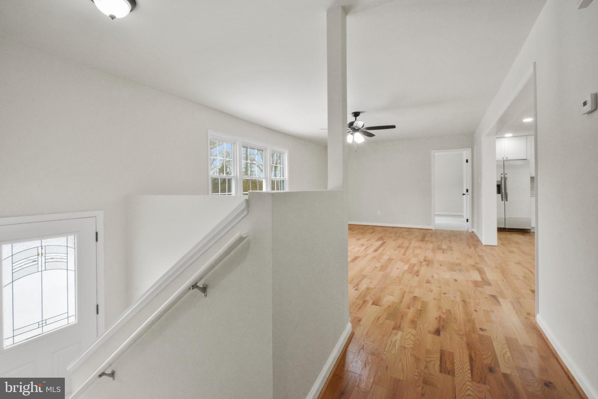 18487 Clay Hill Road Stevensburg, VA 22741 - Photo 10 of 41 a view of a hallway with wooden floor and staircase