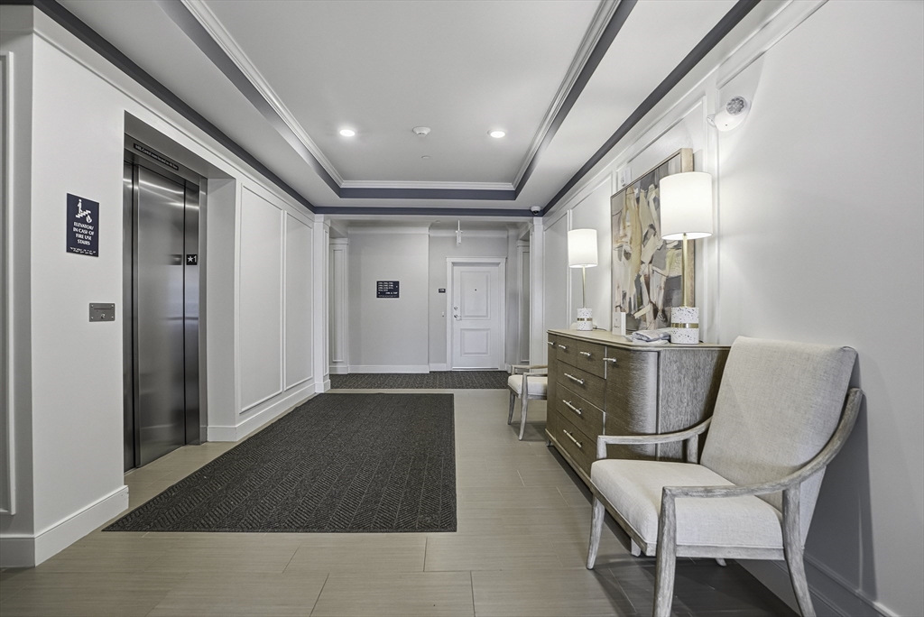 2 Codman Way, Unit 2203 Westborough, MA 01581 - Photo 3 of 36 a view of a hallway with couch and chairs